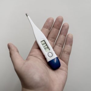 Image of thermometer on a hand